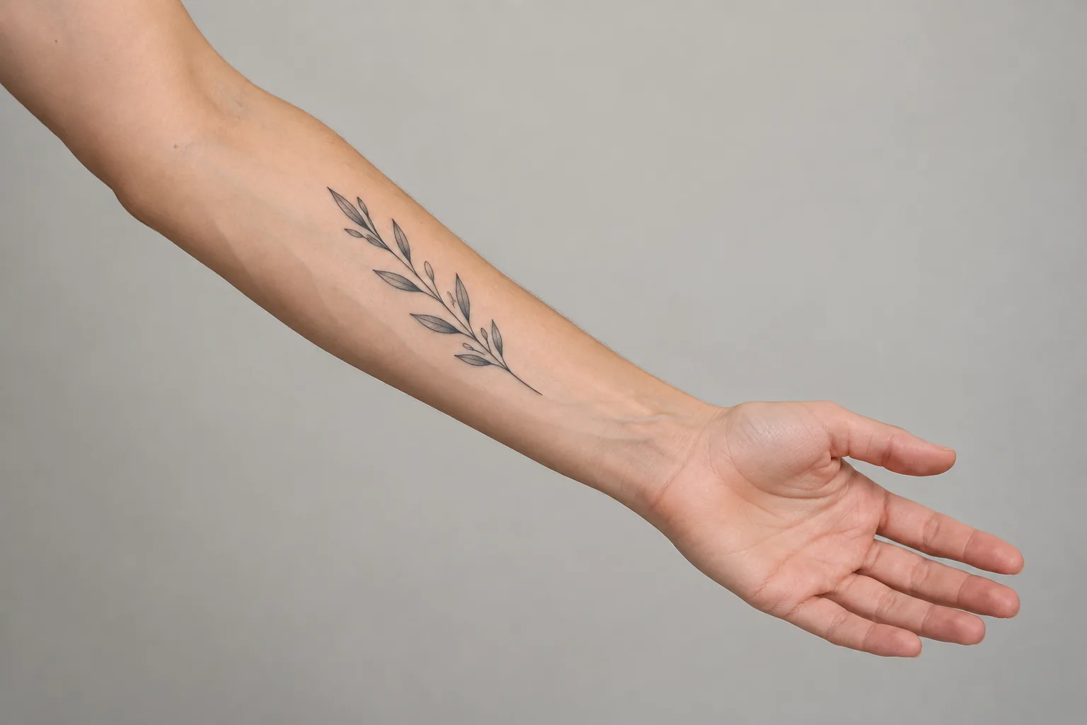 AI-created inner forearm placement reference with palm facing up and a fine-line botanical tattoo.